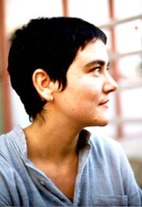 A young woman with short dark hair in profile